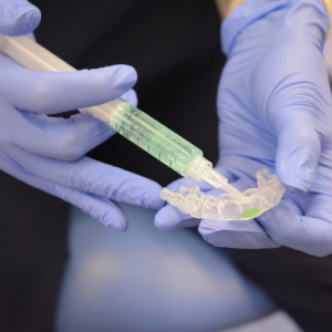 Professional teeth whitening gel applied to custom dental trays